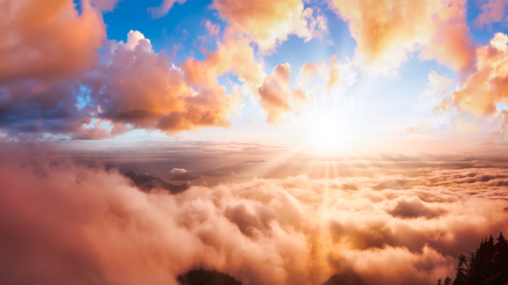 Beautiful Panoramic View of Canadian Mountain Landscape covered in clouds during a vibrant summer sunset. Dramatic Sky Artistic Render. St Mark's Summit, West Vancouver, British Columbia, Canada.